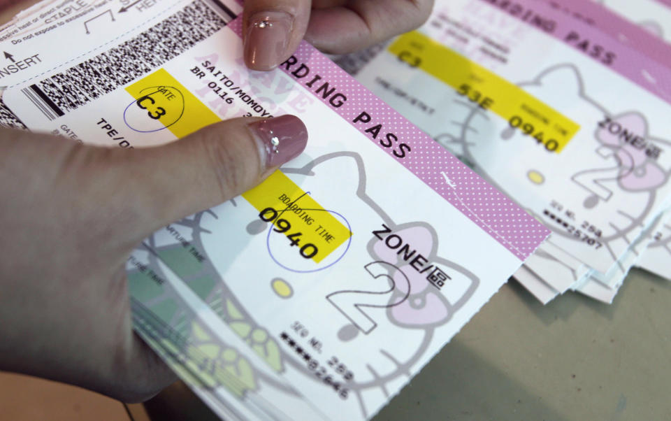 An Eva Airlines ground crew counts Hello Kitty-themed boarding passes in Taoyuan International Airport, northern Taiwan, April 30, 2012. Taiwan's second-largest carrier, Eva Airlines, and Japan's comic company, Sanrio, which owns the Hello Kitty brand, collaborated on the second generation Hello Kitty-themed aircraft which was launched on October 2011. There are currently three Hello Kitty-themed Airbus A330-300 aircrafts flying between cities such as Taipei, Fukuoka, Narita, Sapporo, Incheon, Hong Kong and Guam. REUTERS/Pichi Chuang