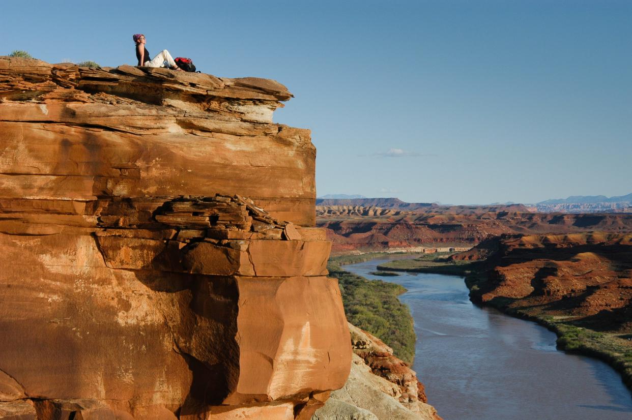 A visitor takes in the sunset along the Green River in Canyonlands National Park.
