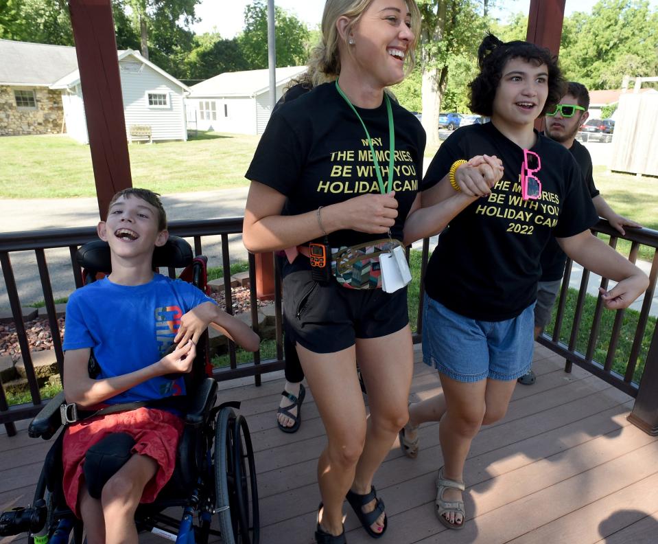 Camp councilor Priscilla Byrd dances with campers Jackson Feldt, 12, (left) and Abby Castiglione, 19, on the opening day of Holiday Camp in Monroe. This year's camp was themed after the Star Wars film franchise.