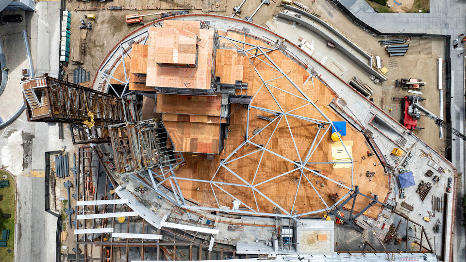 aerial view looking down on a construction site, with metal scaffolding