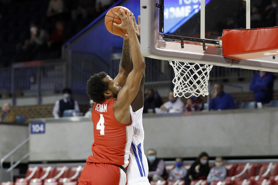 Houston forward Justin Gorham (4) attempts a dunk over the defense of SMU forward Yor Anei, background, during the first half of an NCAA college basketball game in Dallas, Sunday, Jan. 3, 2021. (AP Photo/Roger Steinman)