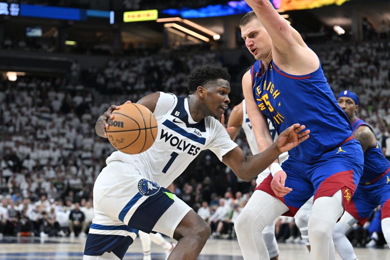 Apr 21, 2023; Minneapolis, Minnesota, USA; Minnesota Timberwolves guard Anthony Edwards (1) goes to the basket as Denver Nuggets center Nikola Jokic (15) defends during the fourth quarter of game three of the 2023 NBA Playoffs at Target Center. Mandatory Credit: Jeffrey Becker-USA TODAY Sports