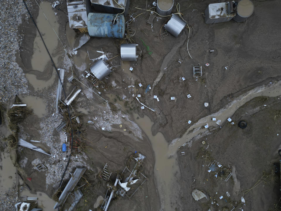 FILE - Floodwaters and mud cover a farm after the country's record rainstorm, in the village of Nea Lefki, in Thessaly region, central Greece, on Sept. 6, 2023. The storms flooded 720 square kilometers (72,000 hectares), mostly prime farmland, totally destroying crops. They also swamped hundreds of buildings, broke the country's railway backbone, savaged local roads and bridges and killed tens of thousands of livestock. Thessaly accounts for about 5% of national economic output, and a much larger proportion of agricultural produce. (AP Photo/Vaggelis Kousioras, File)