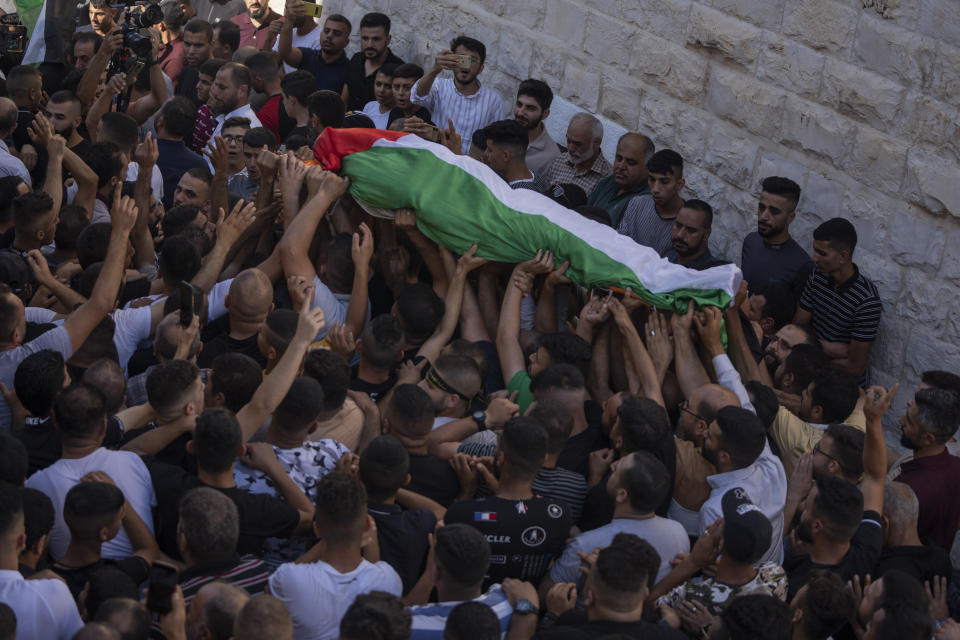 Mourners carry the body of Salah Sawafta, 58 during his funeral in the West Bank city of Tubas, Friday, Aug. 19, 2022. Israeli forces shot and killed Sawafta during an arrest raid in the occupied West Bank on Friday, according to his brother, who said he was walking home when a bullet struck him in the head as Israeli forces clashed with Palestinian youths. (AP Photo/Nasser Nasser)