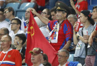 <p>A Russian fan holds a Soviet flag in Sochi </p>