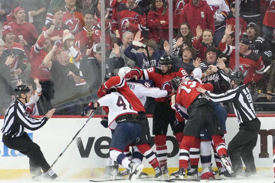 New Jersey Devils and Columbus Blue Jackets fight during the third period of an NHL hockey game Thursday, April 6, 2023, in Newark, N.J. The Devils won 8-1. (AP Photo/Mary Altaffer)