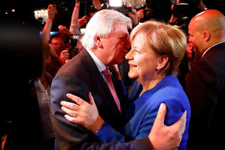 Premier Volker Bouffier of the German state of Hesse greets German Chancellor Angela Merkel of the Christian Democratic Union (CDU) after the TV debate with her challenger Germany's Social Democratic Party SPD candidate for chancellor Martin Schulz in Berlin, Germany, September 3, 2017. German voters will take to the polls in a general election on September 24. REUTERS/Fabrizio Bensch