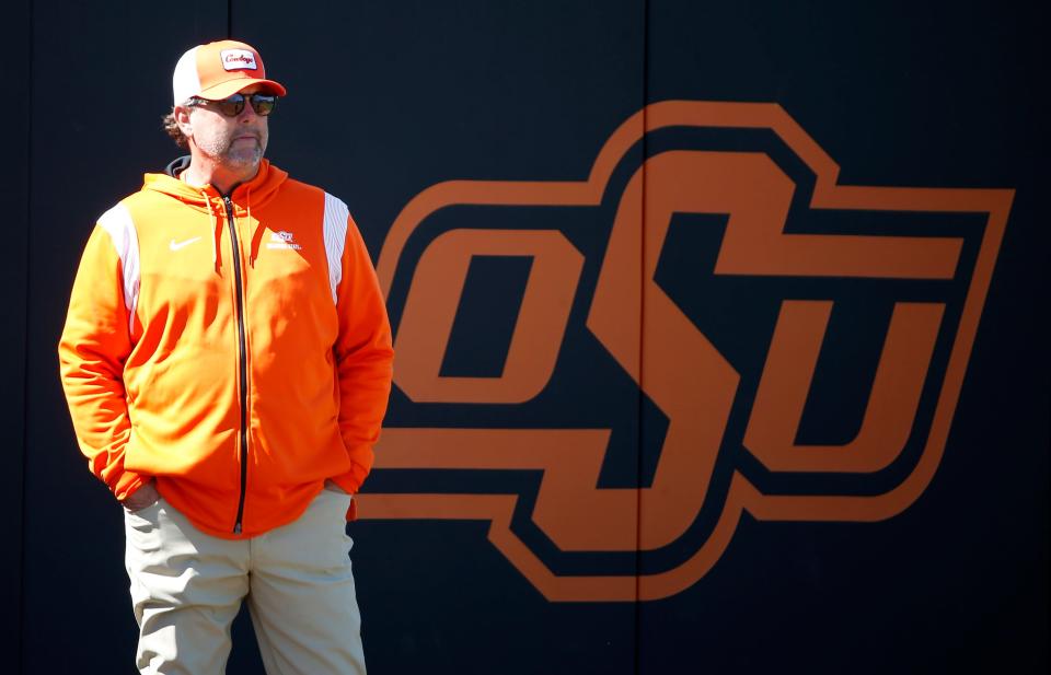 Oklahoma State head coach Kenny Gajewski stands at third base during the college softball game between the Oklahoma State Cowgirls and the Minnesota Golden Gophers in Stillwater, Okla., Saturday, March, 18, 2023. 