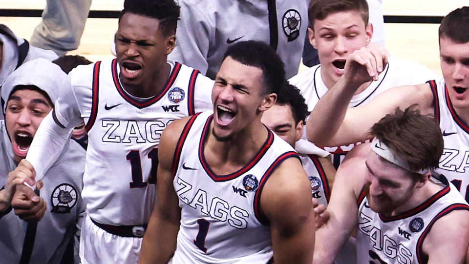 Jalen Suggs and the Gonzaga Bulldogs celebrate after hitting a game-winning three in overtime to advance to the NCAA Tournamen's men's basketball final. (Photo by Andy Lyons/Getty Images)