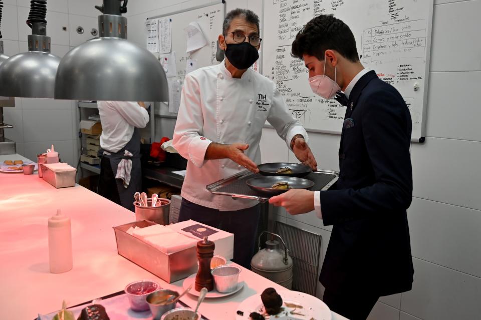 Spanish chef Paco Roncero puts dishes on a tray in his restaurant at the Casino of Madrid in the Spanish capital on November 13, 2020. - Spain has been one of the countries worst affected by the coronavirus pandemic and while its tourism-dependent economy generally did better in the third quarter, a resurgence in cases has led to new restrictions which many fear will once again hit business hard. (Photo by Gabriel BOUYS / AFP) (Photo by GABRIEL BOUYS/AFP via Getty Images)