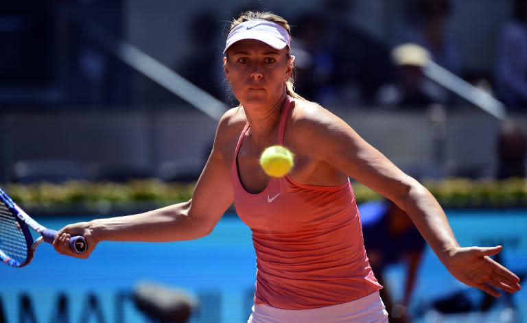 Russian tennis player Maria Sharapova looks at the ball as she prepares to return it during day four of the Madrid Open tournament at the Caja Magica (Magic Box) sports complex in Madrid on May 5, 2015