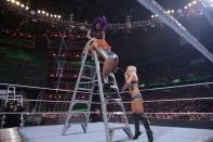 <p>Becky Lynch and Sasha Banks scale the ladder</p>