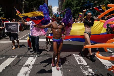 A person waves the flag of Venezuela as they participate in the LGBT Pride March in the Manhattan borough of New York City, U.S., June 25, 2017. REUTERS/Carlo Allegri