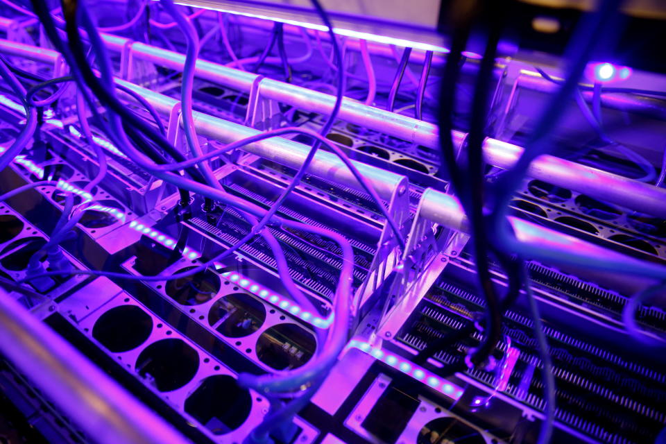 Cryptocurrency miners are seen in a liquid immersion cooling mining tank at the TMG Core stand during the Bitcoin Conference 2022 in Miami Beach, Florida, U.S. April 6, 2022. REUTERS/Marco Bello