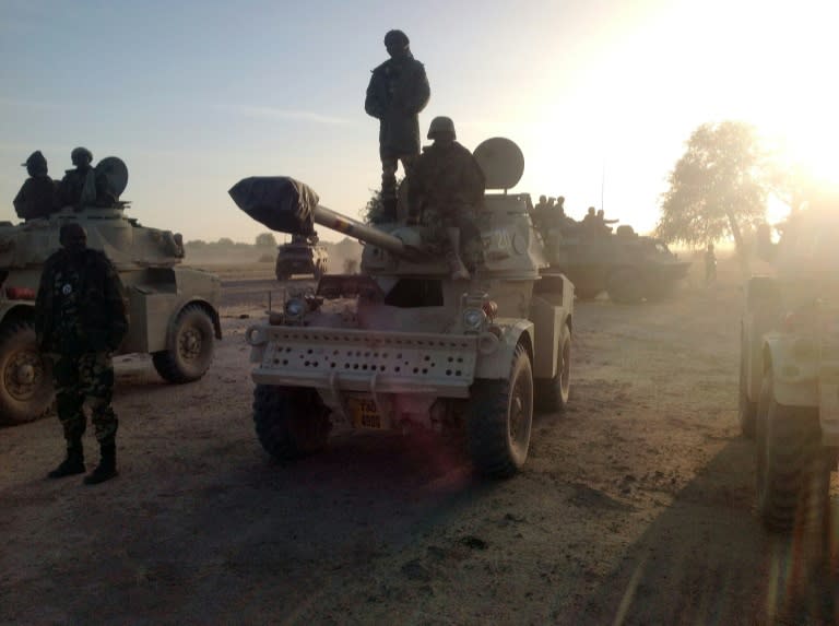 Soldiers of the Chadian army stand next to Panhard AML 90 armoured vehicles on January 21, 2015, at the border between Nigeria and Cameroon