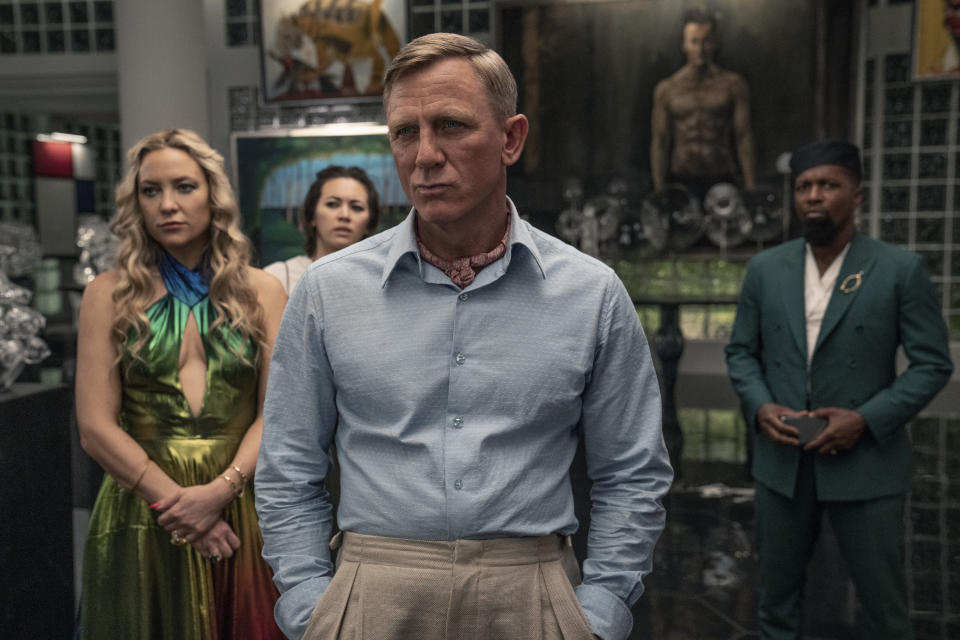 Kate Hudson as Birdie, Jessica Henwick as Peg, Daniel Craig as Detective Benoit Blanc, and Leslie Odom Jr. as Lionel in Glass Onion: A Knives Out Mystery. (Netflix)