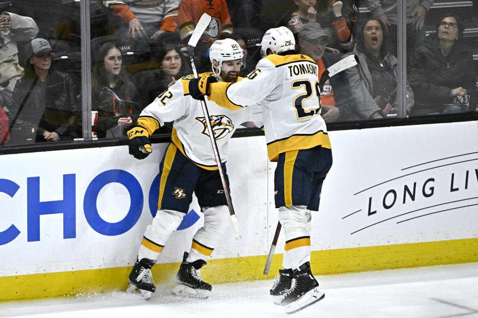 Nashville Predators center Philip Tomasino, right, leaps into center Tommy Novak after Novak scores the game-winning goal against the Anaheim Ducks during the overtime period of an NHL hockey game in Anaheim, Calif., Sunday, March 12, 2023. (AP Photo/Alex Gallardo)