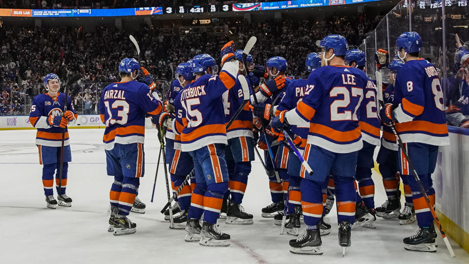 New York Islanders celebrate after defeating Columbus Blue Jackets during extra period of an NHL hockey game, Saturday, Nov. 12, 2022, in Elmont, N.Y. New York Islanders won 4-3. (AP Photo/Eduardo Munoz Alvarez)