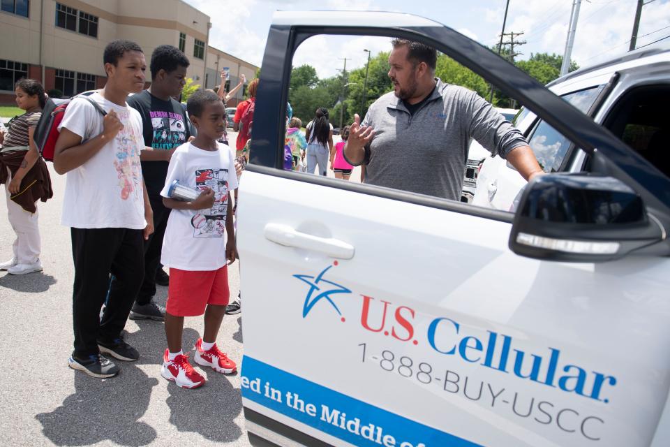 Derick Norris, Senior Optimization Engineer at UScellular, talks with youths from the Boys & Girls Club's Regal Teen Center in Knoxville, Tenn. on Monday, July 11, 2022 about cellular technology and the vehicle he uses to monitor UScellular's wireless network. 