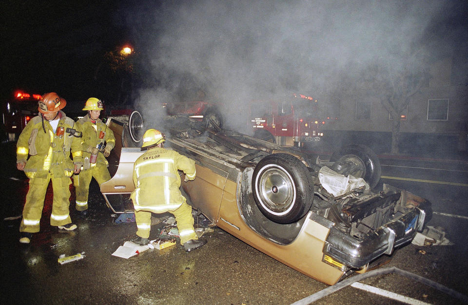 Firefighters with overturned car