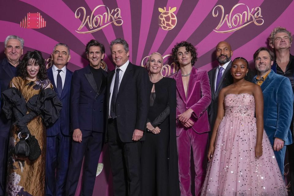 Jim Carter, from left, Sally Hawkins, Rowan Atkinson, Mathew Baynton, Hugh Grant, Olivia Colman, Timothee Chalamet, Keegan-Michael Key, Calah Lane, director Paul King and Simon Farnaby pose for photographers upon arrival at the world premiere of the film 'Wonka' on Tuesday, Nov. 28, 2023 in London. (Scott Garfitt/Invision/AP)