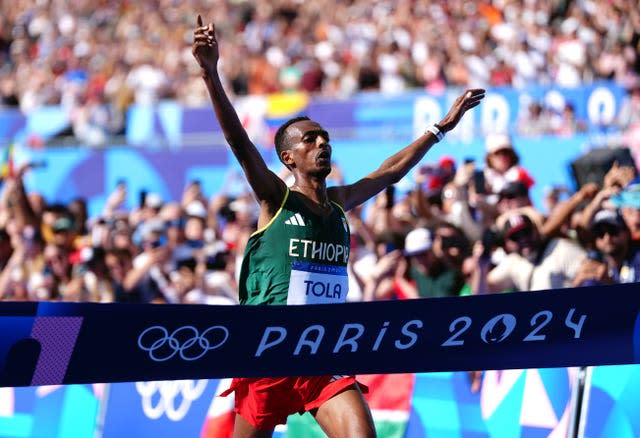 Tamirat Tola crosses the finish line in the Olympic men's marathon