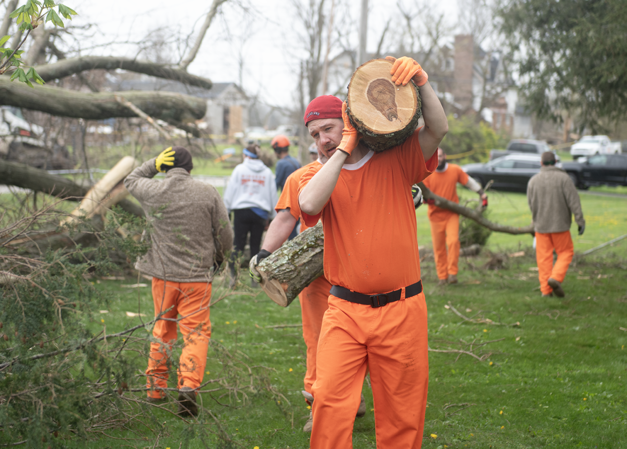 George Hall, a Portage County Jail inmate, helps clear debris from a fallen tree Friday, April 19, 2024, at Windham Cemetery. Lewis is part of the Inmate Training Program in which nonviolent jail inmates can be chosen to work in Portage communities.