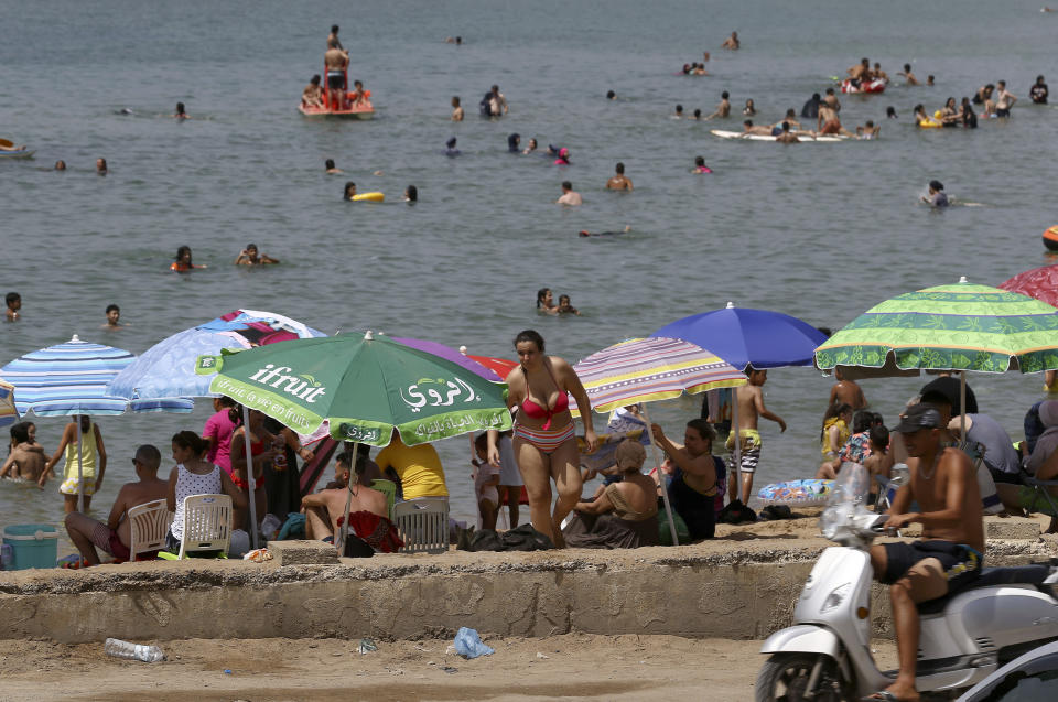 Beachgoers enjoy the el Djamila beach after its reopening in Algiers, Saturday, Aug.15, 2020. Algeria started to reopen mosques, cafes, beaches and parks Saturday after five months of virus confinement measures. Curfews are still in place in more than half of the country, which has reported more than 37,000 infections and 1,350 deaths, the third-highest virus death rate in Africa. (AP Photo/Anis Belghoul)