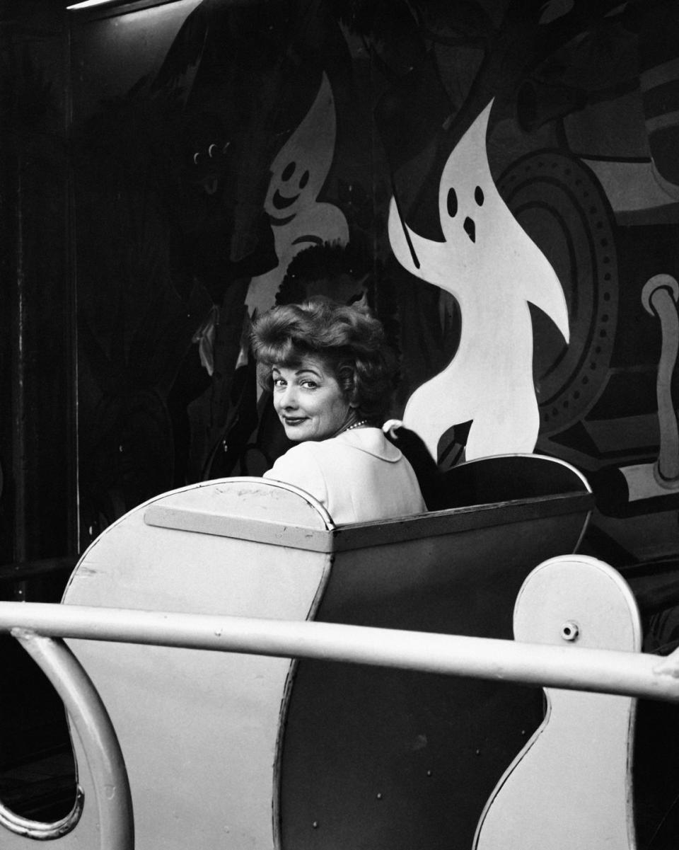 1955: On a ride with her daughter Lucie at an amusement park in Paris.