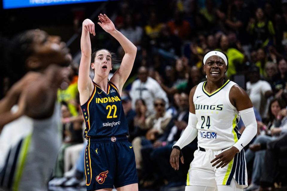 Indiana Fever guard Caitlin Clark (22) takes a shot over Dallas Wings guard Arike Ogunbawale (24) in the first quarter of a WNBA preseason game against the Dallas Wings at College Park Center in Arlington on Friday, May 3, 2024.
