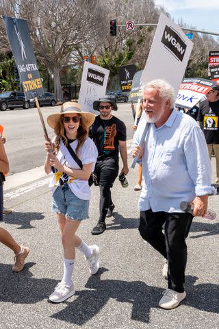 <p>Amanda Edwards/Getty</p> Anna Kendrick takes part in SAG-AFTRA strike in Los Angeles with writer Larry Karaszewski
