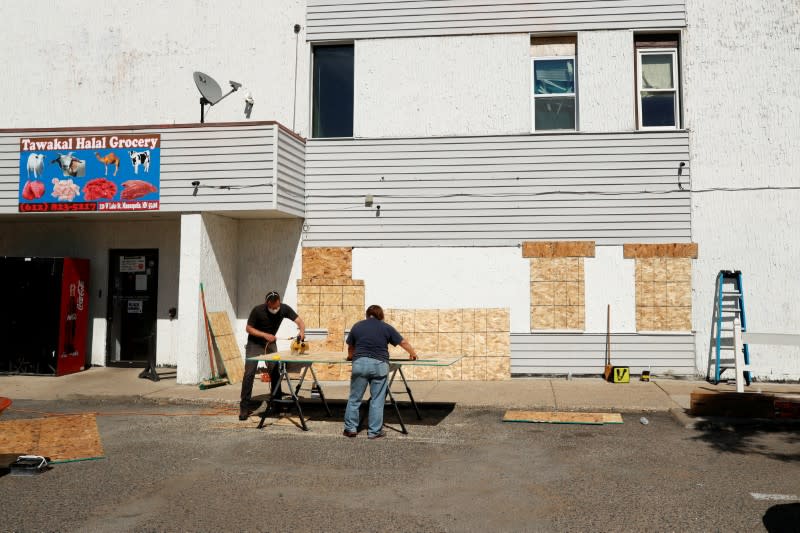 FILE PHOTO: People work outside Tawakal Halal Grocery store following the protests against the death in Minneapolis police custody of George Floyd, in Minneapolis