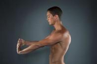 Diver Thomas Finchum stretches while posing for a portrait during the 2012 U.S. Olympic Team Media Summit in Dallas, May 15, 2012.