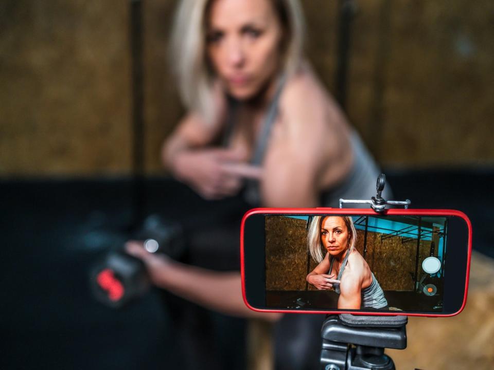 Fitness vlogger making a video of herself at the gym (Getty Images) (Getty Images)