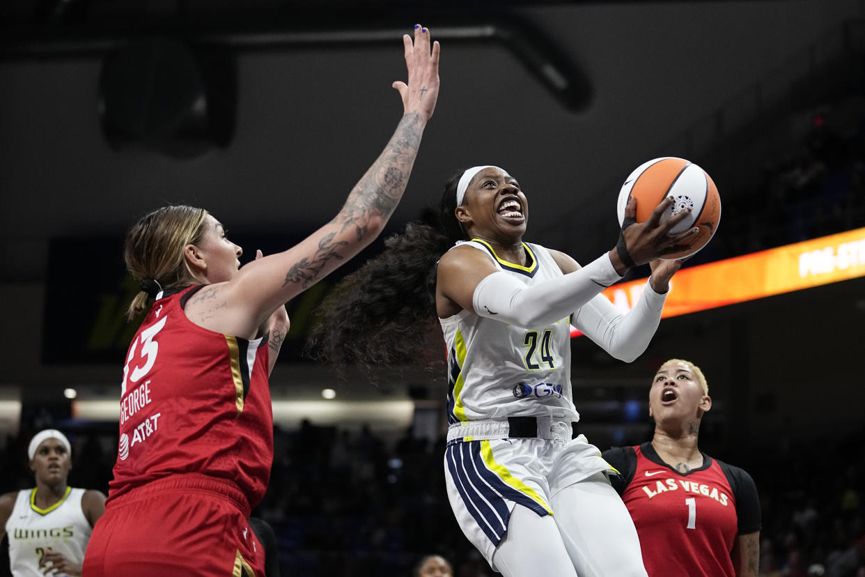 Dallas Wings guard Arike Ogunbowale gets through the Las Vegas Aces' Cayla George and Kierstan Bell for a shot attempt on Aug. 8, 2023, in Arlington, Texas. (AP Photo/Tony Gutierrez)