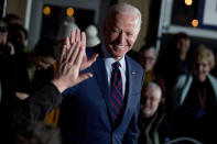 FILE - In this Jan. 5, 2020, file photo Democratic presidential candidate, former Vice President Joe Biden high-fives a member of the audience during a campaign rally at Modern Woodmen Park in Davenport, Iowa Biden has won the last few delegates he needed to clinch the Democratic nomination for president. (AP Photo/Andrew Harnik, File)