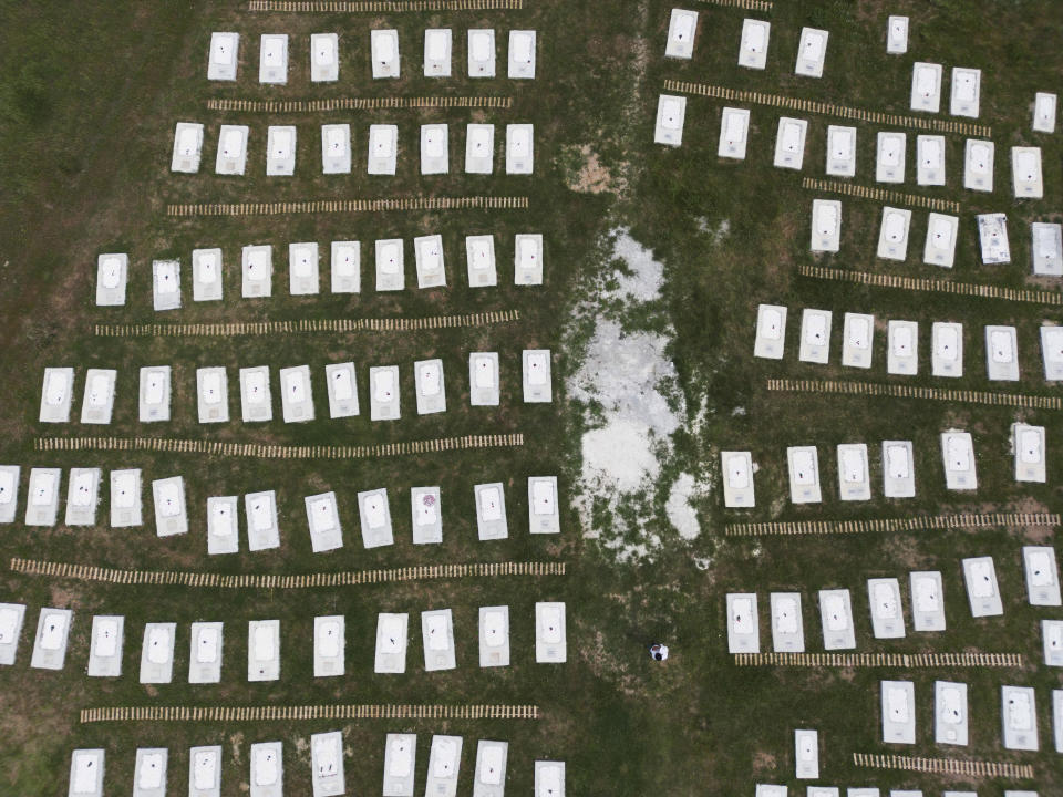 A cemetery is seen from above at Kato Tritos village on the northeastern Aegean Sea island of Lesbos, Greece, on Wednesday, April 17, 2024. After years of neglect, a primitive burial ground for refugees who died trying to reach Greece's island of Lesbos has been cleaned up and redesigned to provide a dignified resting place for the dead. (AP Photo/Panagiotis Balaskas)