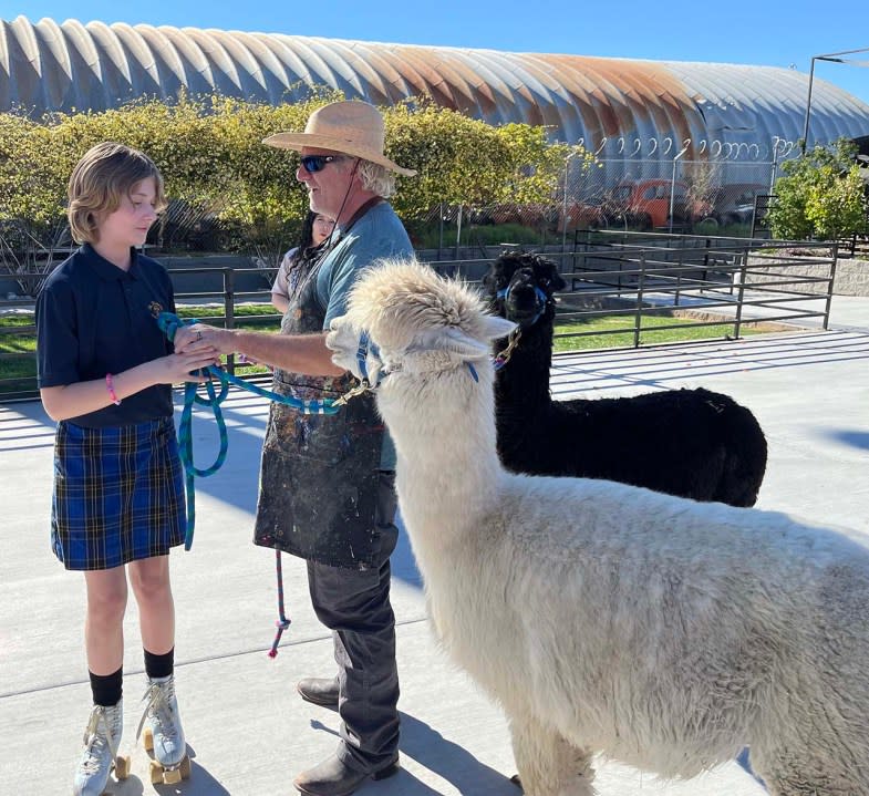 <em>Steve Spann with his daughter, Maye, and the two alpacas at The Doyle. (Greg Haas / 8NewsNow)</em>