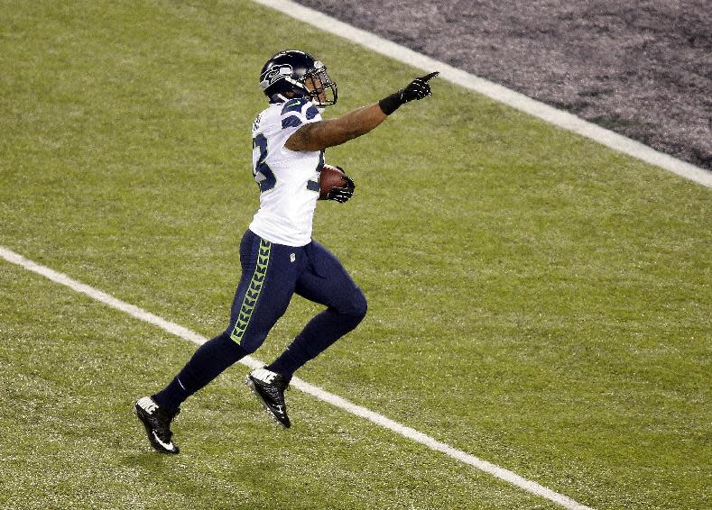 Seattle Seahawks' Malcolm Smith (53) runs back an interception for a touchdown during the first half of the NFL Super Bowl XLVIII football game against the Denver Broncos Sunday, Feb. 2, 2014, in East Rutherford, N.J. (AP Photo/Charlie Riedel)