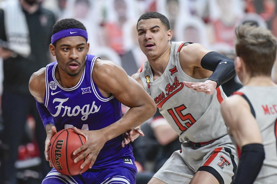 TCU's Kevin Easly Jr. (34) controls the ball against Texas Tech's Kevin McCullar (15) during the first half of an NCAA college basketball game in Lubbock, Texas, Tuesday, March 2, 2021. (AP Photo/Justin Rex)