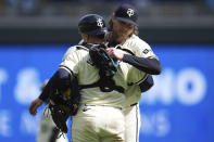 Minnesota Twins pitcher Steven Okert, right, and catcher Christian Vázquez hug after a 3-2 win in a baseball game against the Los Angeles Dodgers,Wednesday, April 10, 2024, in Minneapolis. (AP Photo/Abbie Parr)