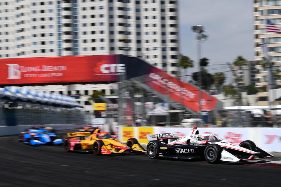 Apr 10, 2022; Long Beach, California, USA; Team Penske driver Josef Newgarden (2) of United States leads driver Romain Grosjean (28) and driver Álex Palou (10) during the Grand Prix of Long Beach at Long Beach Street Circuit.