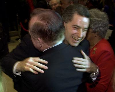 In this 2001 photo Jim McGreevey, mayor of Woodbridge, N.J.,  smiles as he hugs his father, Jack, at John F. Kennedy High School in Woodbridge after announcing his candidacy for New Jersey governor.