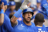 Kansas City Royals' Salvador Perez celebrates in the dugout after hitting a home run during the eighth inning in the first baseball game of a doubleheader against the Chicago White Sox, Wednesday, April 17, 2024, in Chicago. (AP Photo/Erin Hooley)