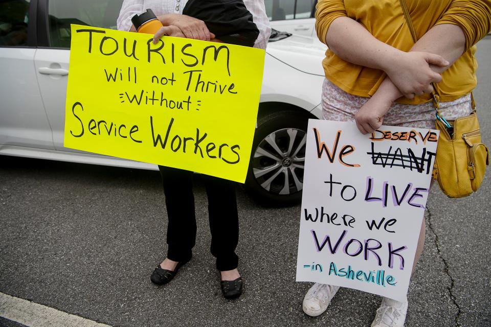 Asheville community members rallied for affordable housing before entering the Buncombe County Tourism Development Authority meeting May 31, 2023.