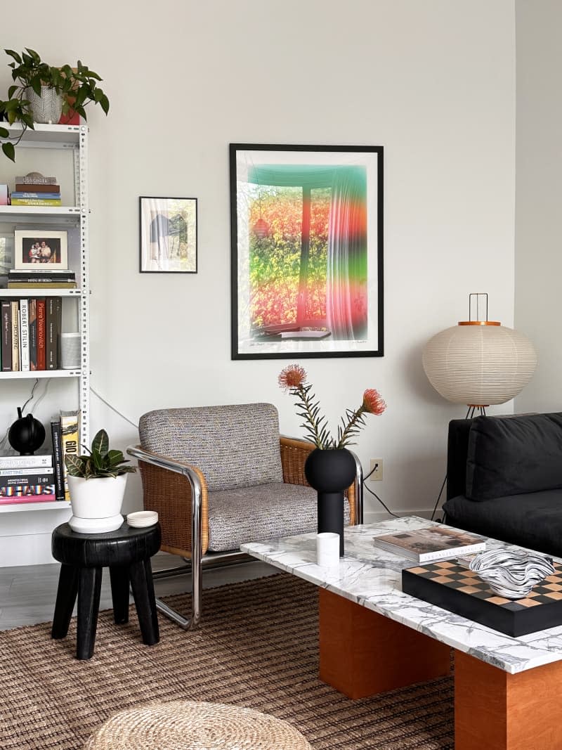 Marble-topped table and fabric chair in a living room area.