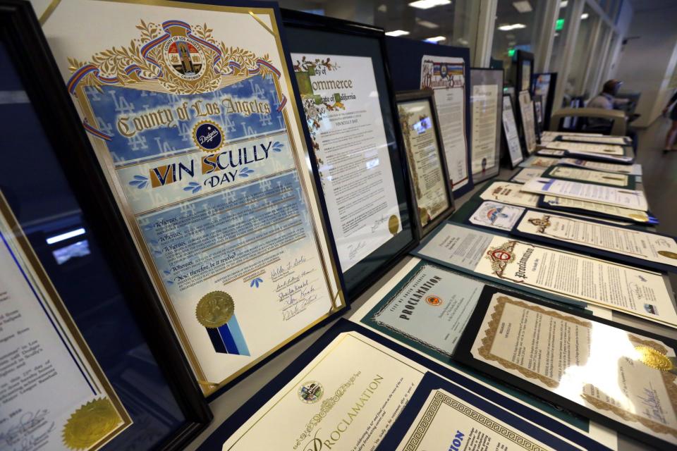 <p>Proclamations from more than 40 cities and municipalities, declaring Sept. 23 as Vin Scully Day, are on display in the Vin Scully Pressbox before the Los Angeles Dodgers Hall of Fame broadcaster is honored in a ceremony before a baseball game against the Colorado Rockies at Dodger Stadium, Friday, Sept. 23, 2016. (AP Photo/Reed Saxon) </p>