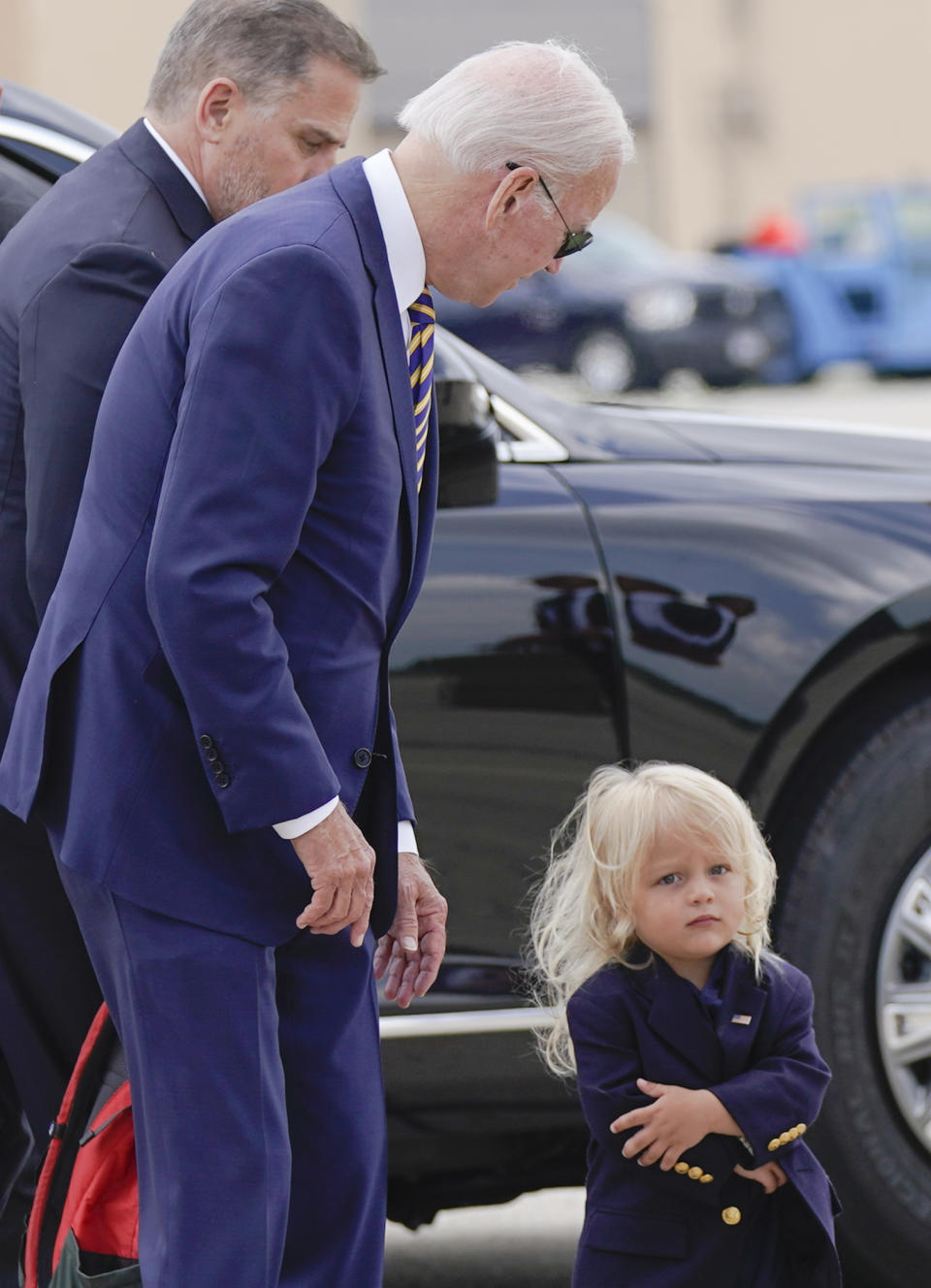 President Joe Biden looks at his grandson Beau Biden as he walks to board Air Force One with his son Hunter Biden at Andrews Air Force Base, Md., Wednesday, Aug. 10, 2022. The President is traveling to Kiawah Island, S.C., for vacation. (AP Photo/Manuel Balce Ceneta)