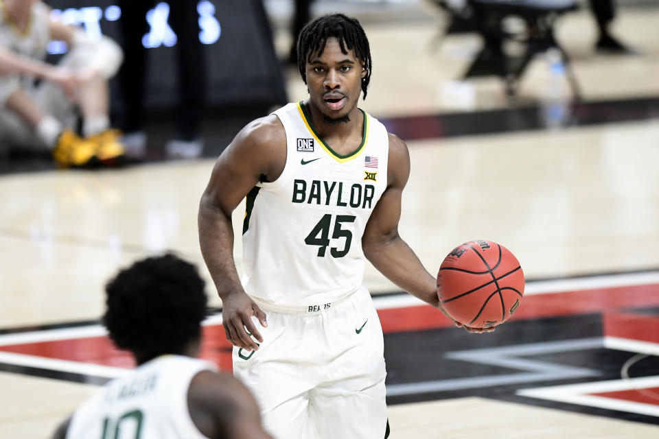 Baylor's Davion Mitchell (45) controls the ball during the first half of an NCAA college basketball game against Texas Tech in Lubbock, Texas, Saturday, Jan. 16, 2021. (AP Photo/Justin Rex)