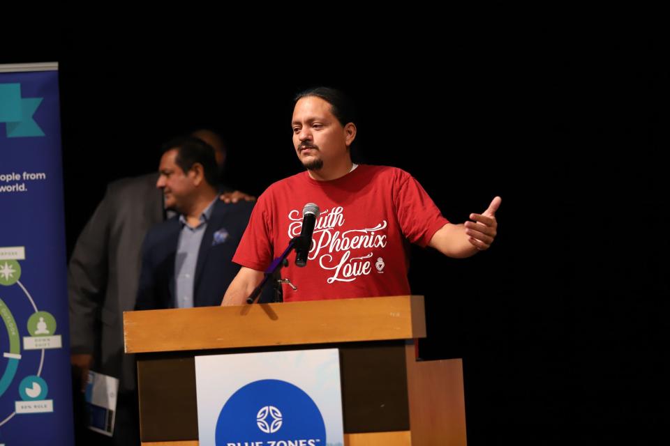 District 8 Councilmember Carlos Garcia addresses the audience at the Blue Zones kickoff event March 28. He pointed to historical issues like slavery, colonization and exploitation that has resulted in a steep life expectancy gap in south Phoenix. In some ZIP codes, life expectancy is 14 years shorter than other communities in Phoenix.